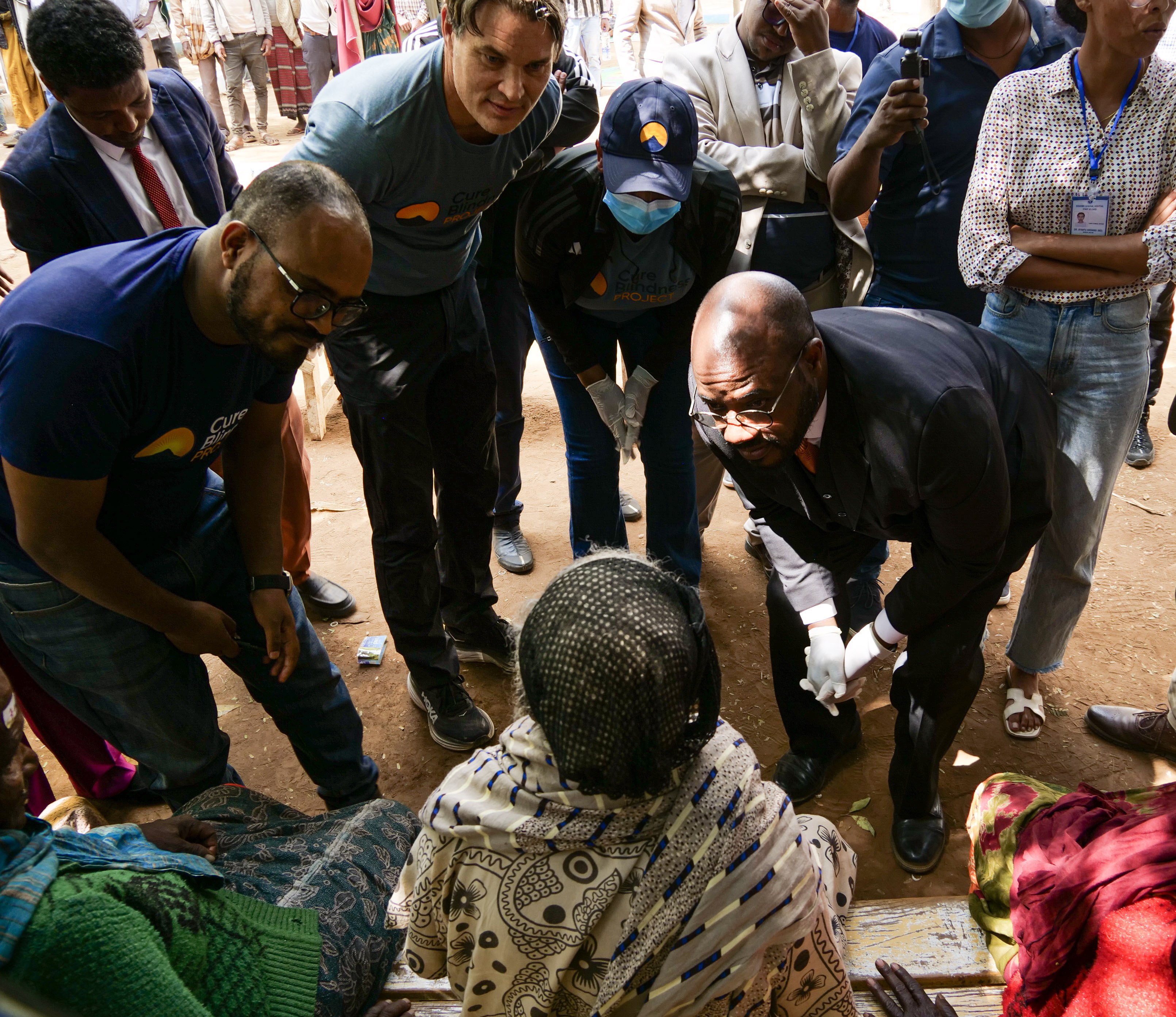 U.S. Ambassador to Ethiopia Ervin Massinga removes patient's eye patches after surgery